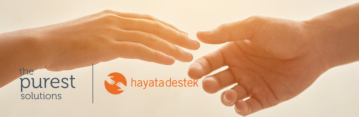 The Purest Solutions ve Hayata Destek Derneği iş birliği kapak görseli: birbirine uzanan iki el ve iki logo